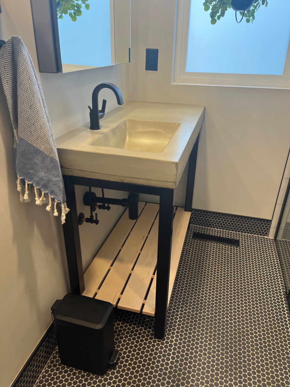 Console sink with a black faucet
